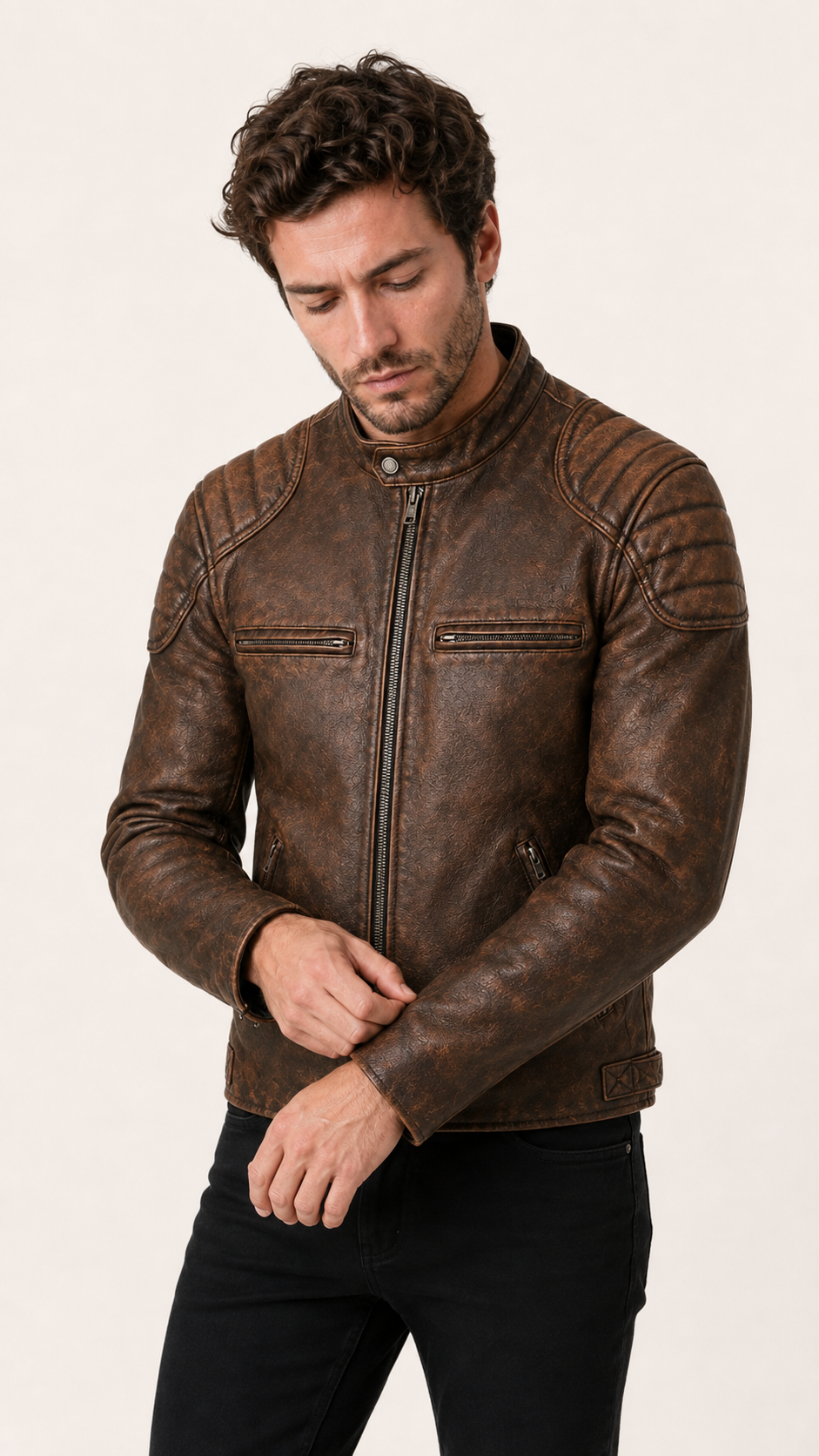 British model inspecting the cuff of the distressed brown biker jacket