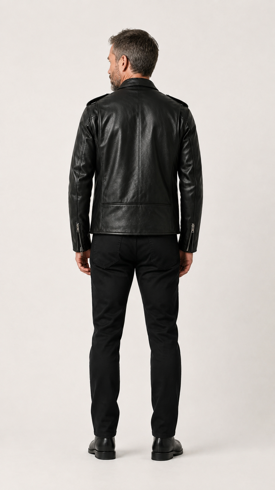 Full-length back view of a man in the black double rider jacket — British model