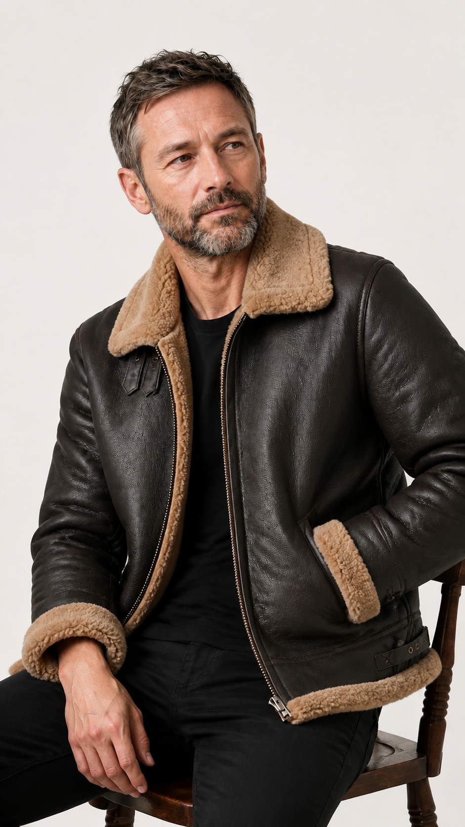 Man seated wearing the brown B-3 shearling flight jacket — British model