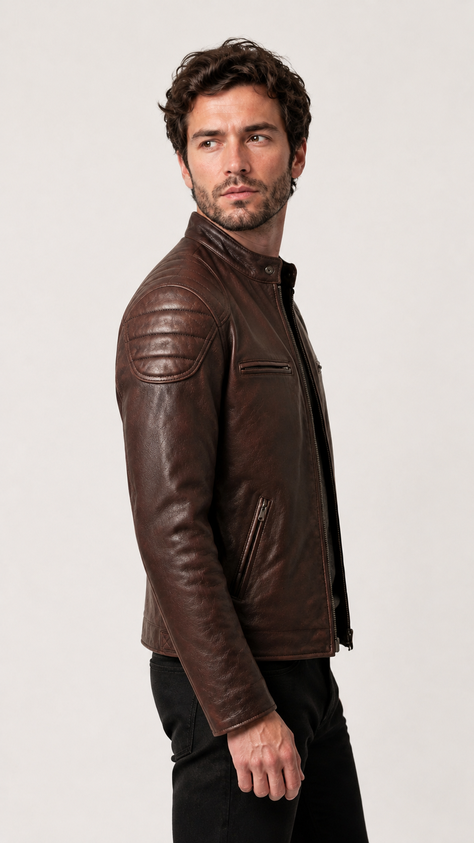 Side profile of a man wearing the vintage brown biker jacket — British model